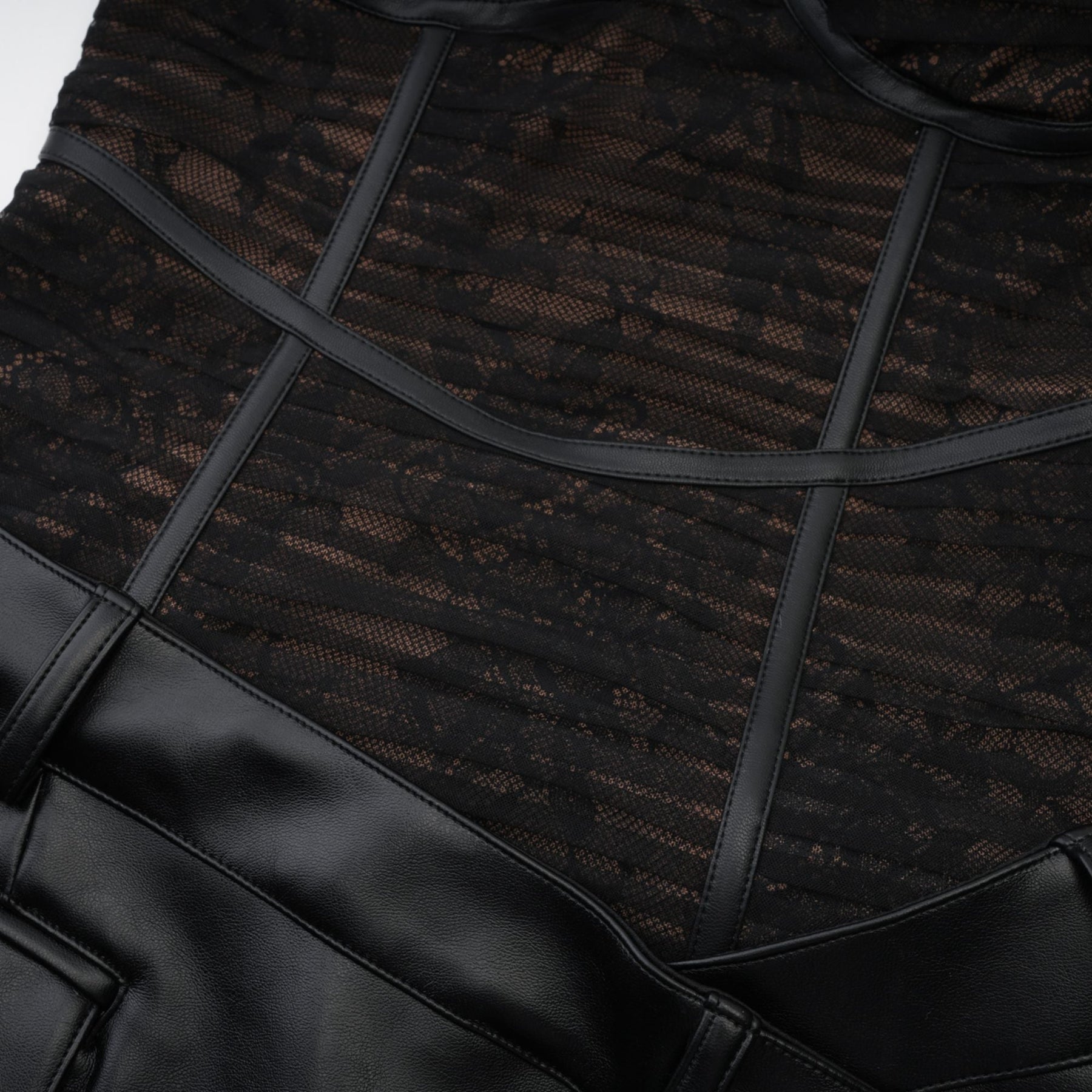 Formfitting black dress with mesh details and a fauxleather finish