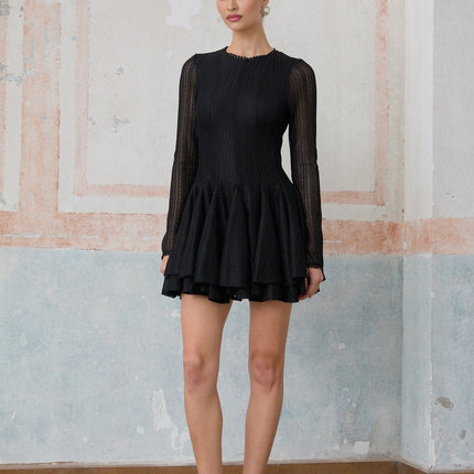 A black mini dress with puff sleeves and pointelle knit detailing named Helene