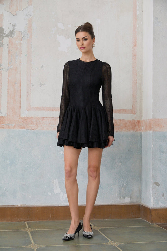A black mini dress with puff sleeves and pointelle knit detailing named Helene