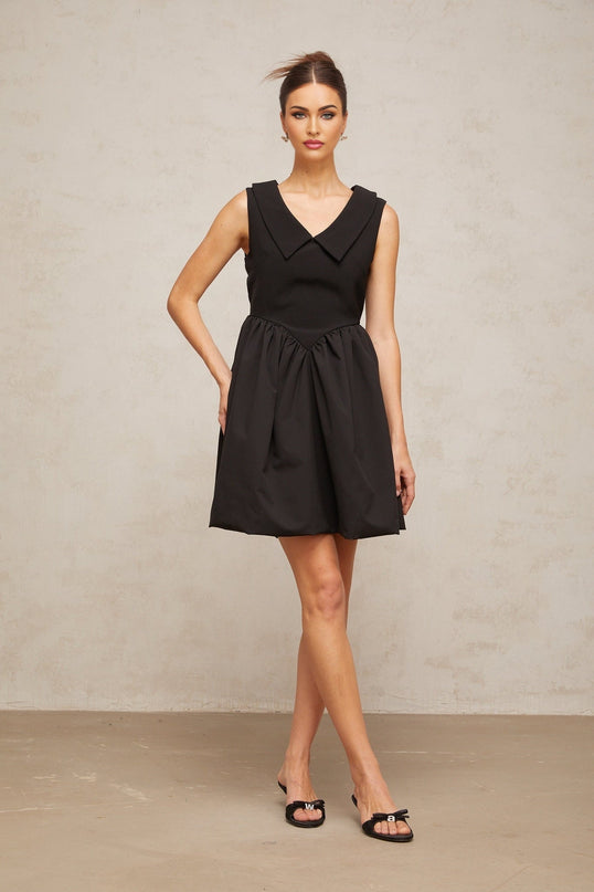 A black mini dress with puffed sleeves and a lapel collar featuring a fitted silhouette and short hemline