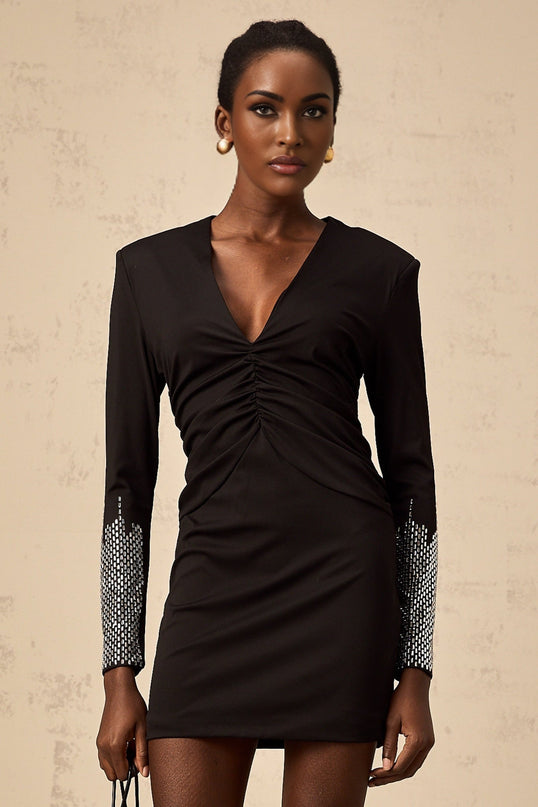 A black mini dress with rhinestone embellishments and gathered fabric detailing featuring a design by Suzy