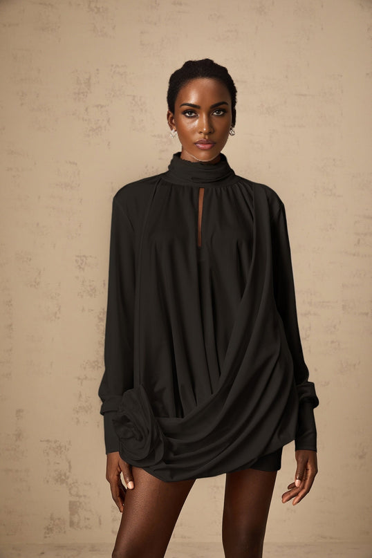 A black mini dress with ruched detailing and faux flower embellishments featuring a formfitting silhouette and short length