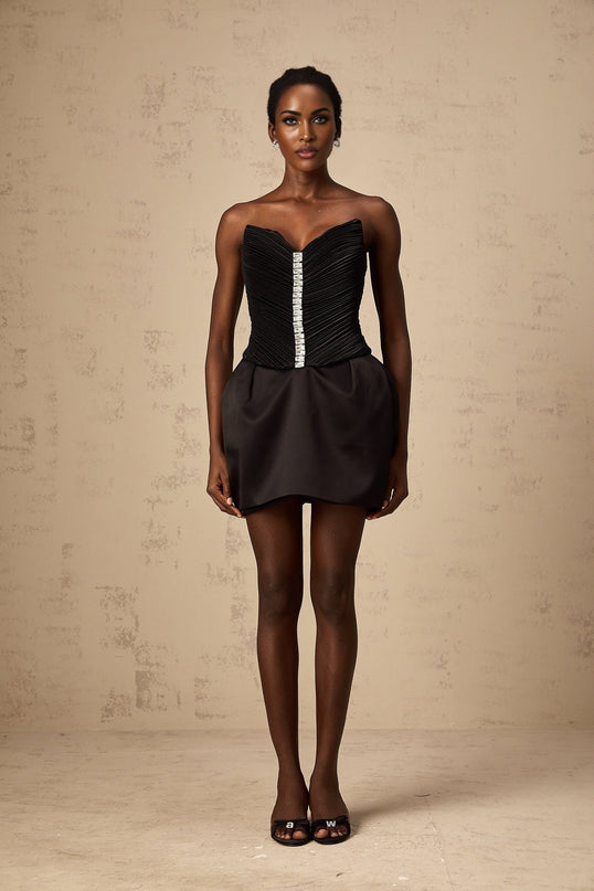 A black mini dress with ruched detailing and puff sleeves called the Francis dress