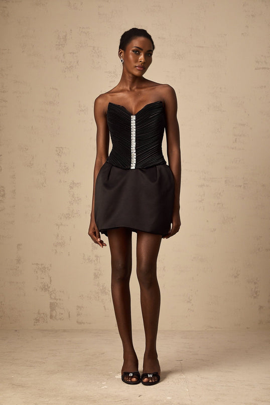 A black mini dress with ruched detailing and puff sleeves named Francis