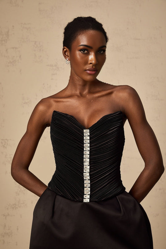 A black mini dress with ruched detailing and puff sleeves named Francis