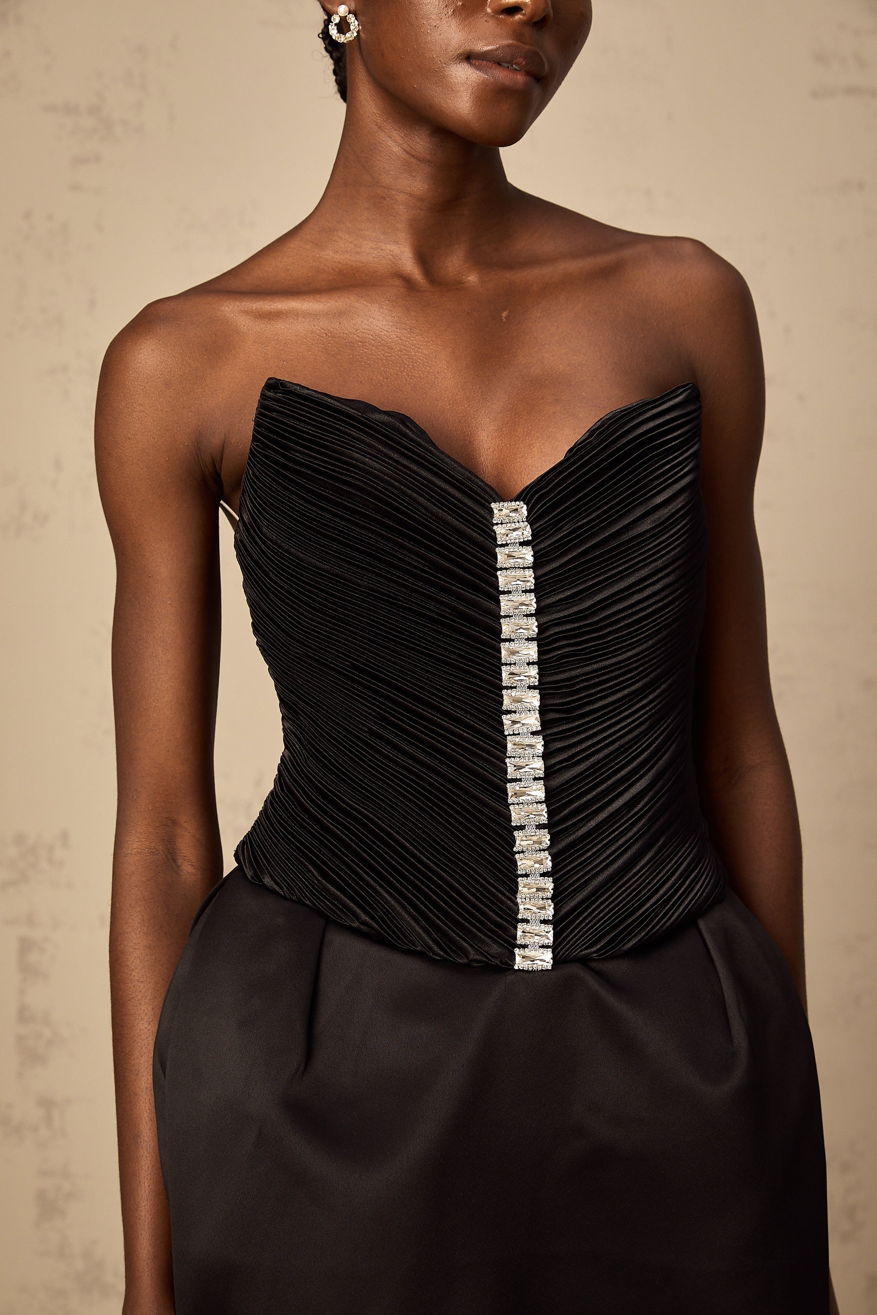 A black mini dress with ruched detailing and puff sleeves named Francis