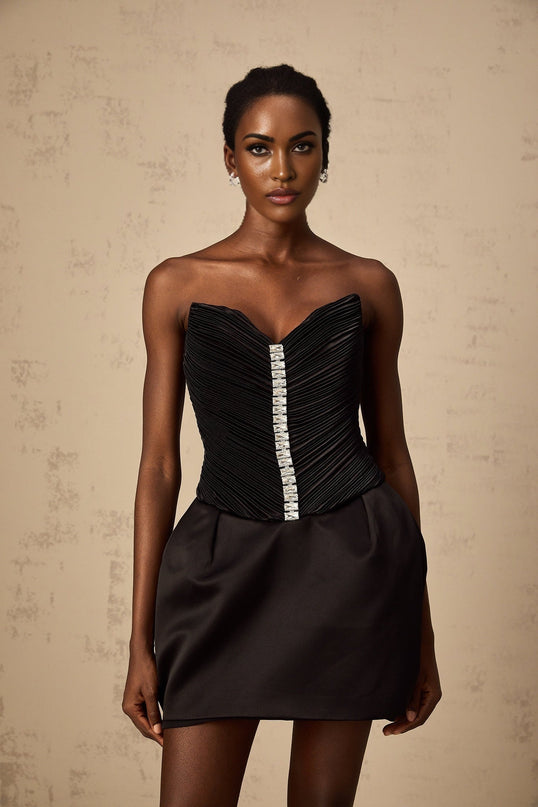 A black mini dress with ruched detailing and puff sleeves named Francis