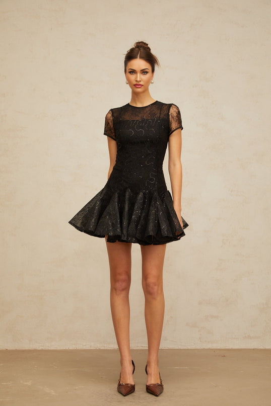 A black mini dress with sequin embellishments and a flared skirt design called Lara