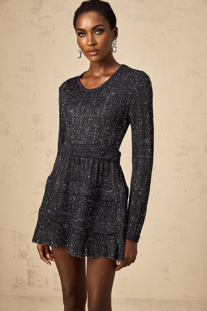 A black mini dress with sequin embellishments and a knitted texture featuring a short hemline and likely formfitting silhouette