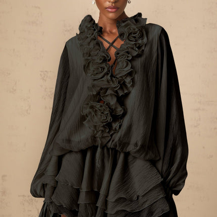 A black mini dress with tiered layers and floral applique details named Zephyrine