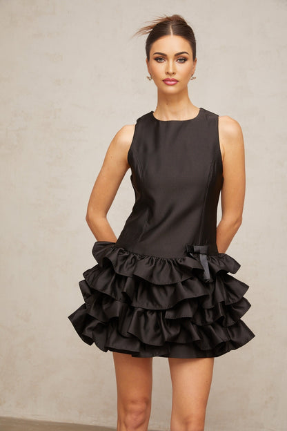 A black mini dress with tiered ruffles and a short hemline named Therese