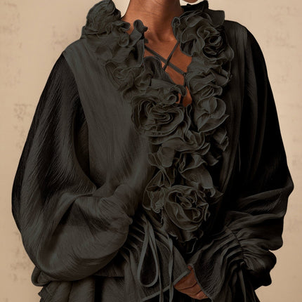 A black mini dress with tiered skirt and floral appliques called Zephyrine