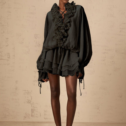 A black mini dress with tiered skirt and floral appliques named Zephyrine