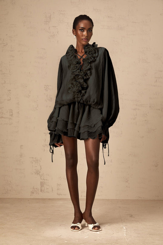 A black mini dress with tiered skirt and floral appliques named Zephyrine