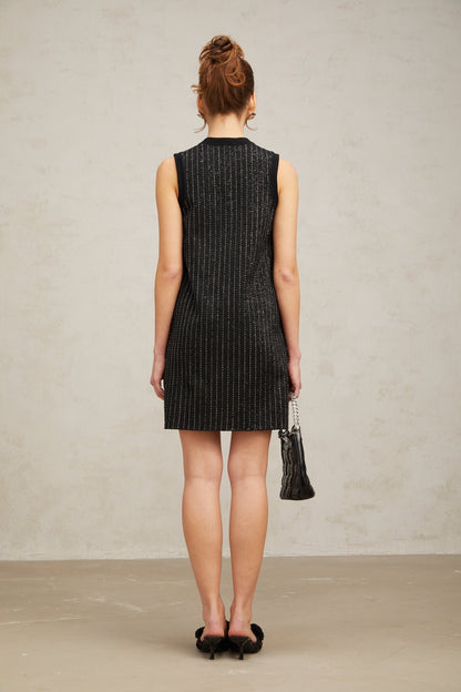 A black mini dress with vertical stripes and sequin embellishments featuring a knit fabric and a short hemline inspired by Zelda style
