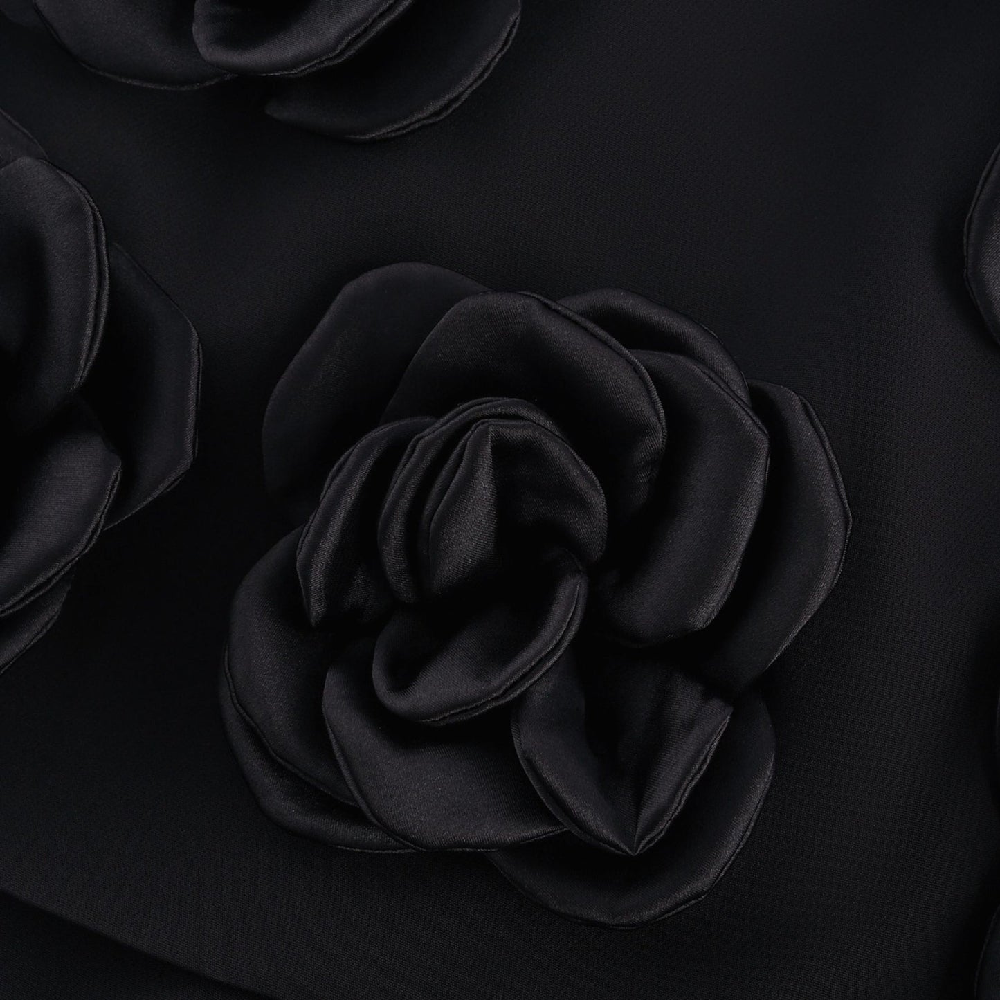 Black dress with fauxflower adornment side zip thigh lengthbr
