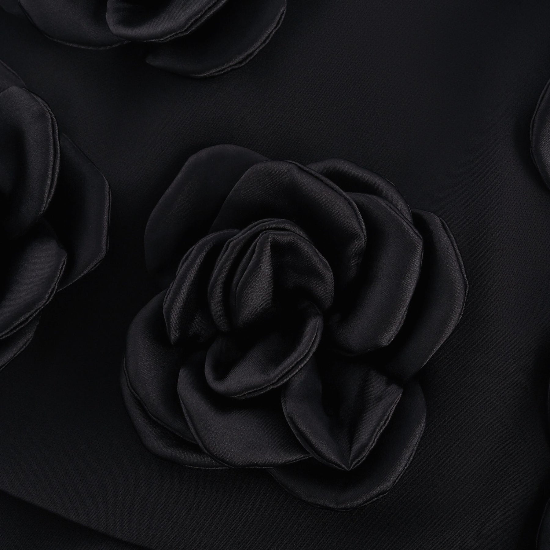 Black dress with fauxflower adornment side zip thigh lengthbr