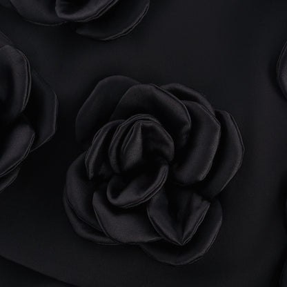 Black dress with fauxflower adornment side zip thigh lengthbr