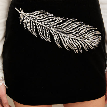 A black mini skirt with embellished feather embroidery details named Myriam
