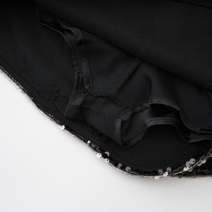 Black dress with sparkling finish adorned with sequins rear zip closure straight hem thighlength 100% Polyester composition