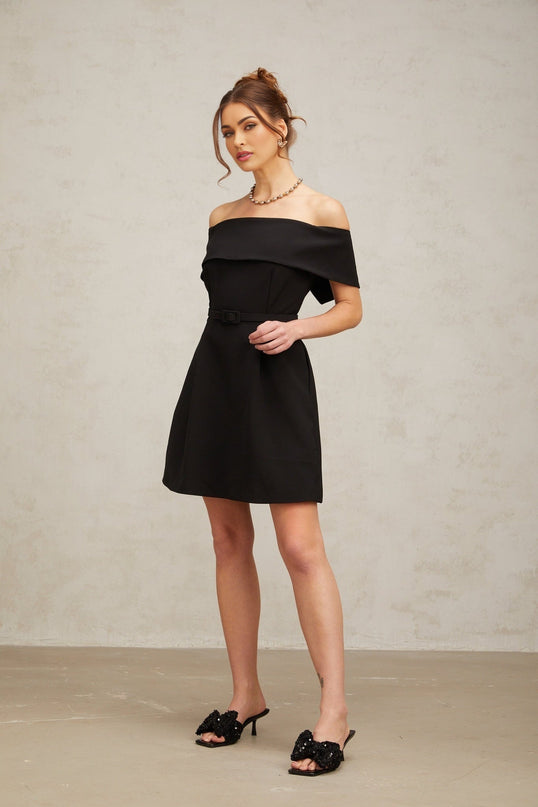 A black off shoulder mini dress with a belt cinching the waist featuring a sleek and elegant design