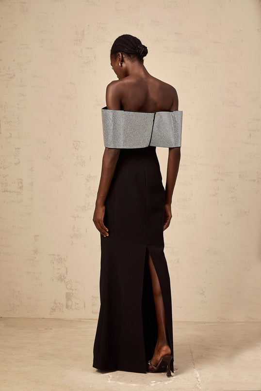 A black offshoulder maxi dress by Chloé featuring a rhinestone bow detail