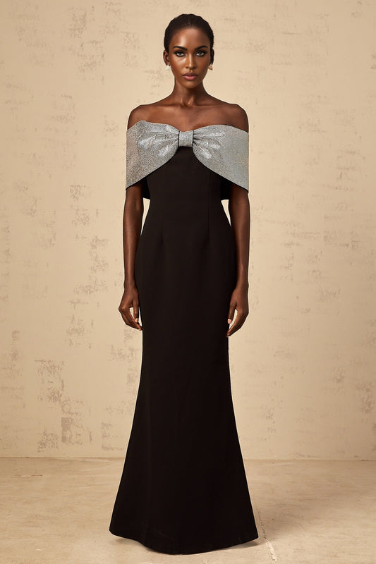 A black offshoulder maxi dress with a rhinestone bow detail by Chloé