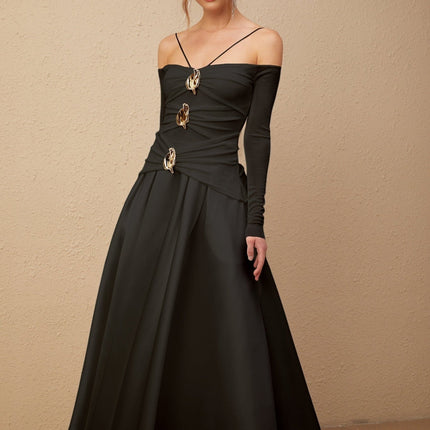 A black offshoulder maxi dress with panelled design worn by a model named Nadine