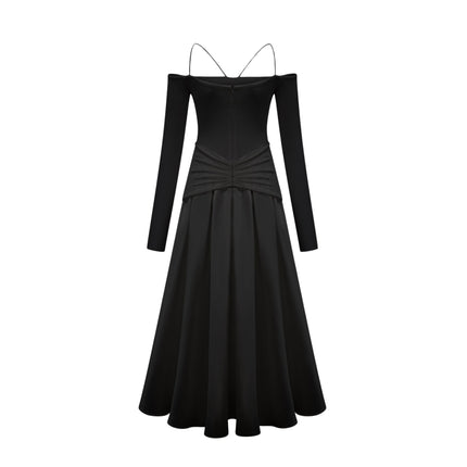 A black offshoulder maxi dress with panelled design worn by a model standing against a plain background