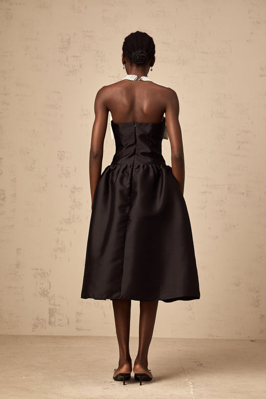 A black offshoulder midi dress made of georgette fabric featuring a bow detail at the neckline