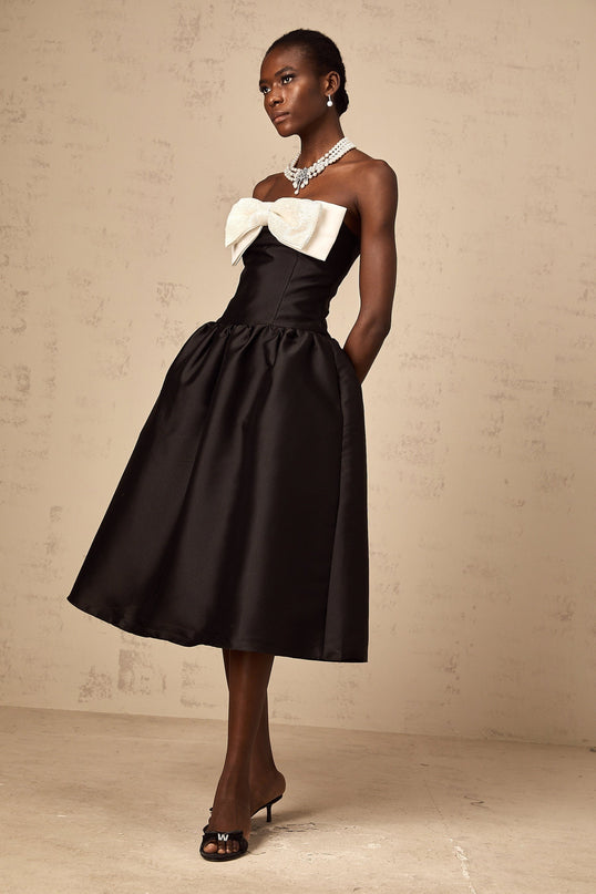 A black offshoulder midi dress made of georgette fabric featuring a bow detail at the neckline