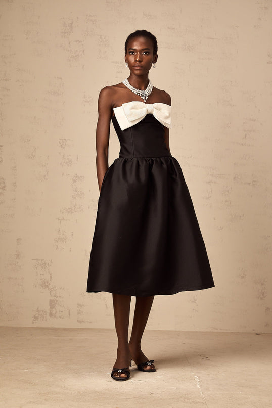 A black offshoulder midi dress made of georgette fabric featuring a bow detail at the neckline