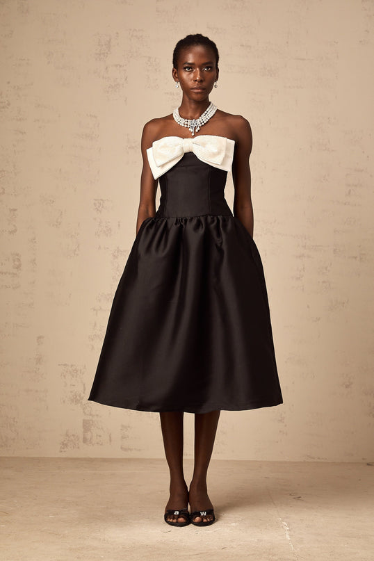 A black offshoulder midi dress made of georgette fabric featuring a bowknot detail