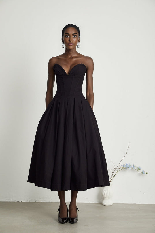A black offshoulder midi dress with a corsetstyle bodice worn by a model named Katherine