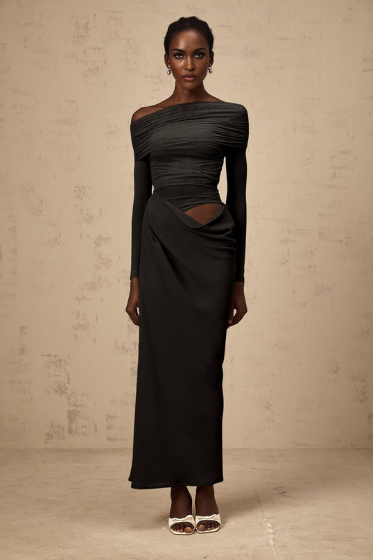 A black offshoulder midi dress with a semisheer design named Estelle worn by a model