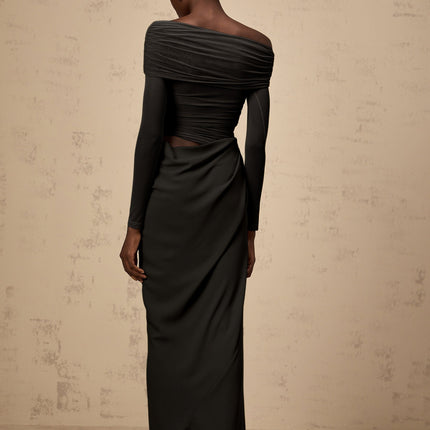 A black offshoulder midi dress with a semisheer design worn by a model standing against a plain background