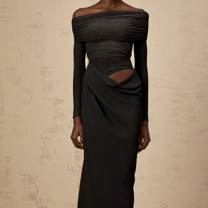 A black offshoulder midi dress with a semisheer design worn by a model standing against a plain background