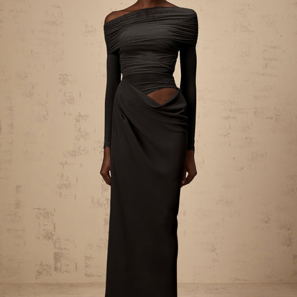 A black offshoulder midi dress with semisheer fabric worn by a model standing against a plain background