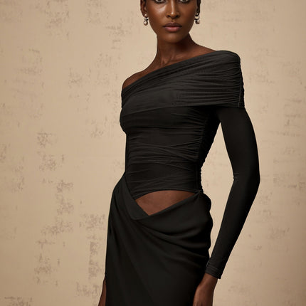 A black offshoulder midi dress with semisheer fabric worn by a model standing against a plain background