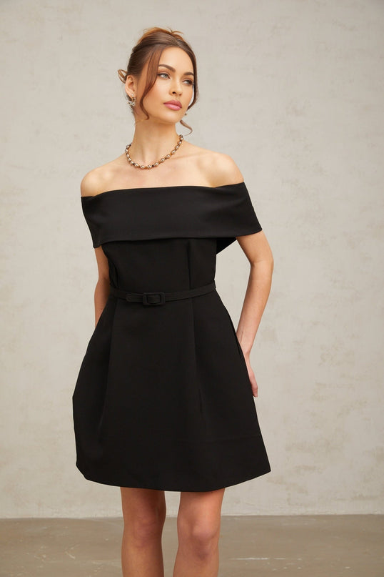 A black offshoulder mini dress with a belt at the waist named Greta