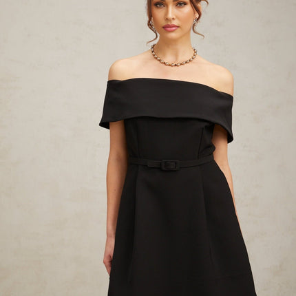 A black offshoulder mini dress with a belt cinching the waist named Greta