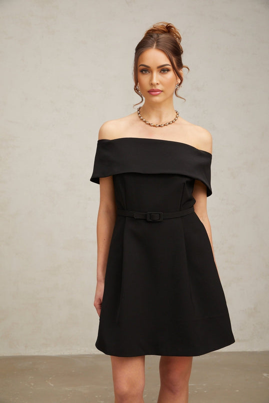 A black offshoulder mini dress with a belt cinching the waist named Greta