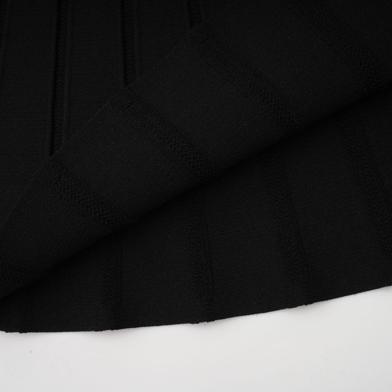 A black offshoulder mini dress with a bow detail and knit fabric featuring a fitted silhouette and short length