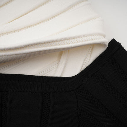 A black offshoulder mini dress with a bow detail and knit fabric featuring a fitted silhouette and short length