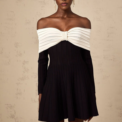 A black offshoulder mini dress with a bow detail and knit fabric featuring a fitted silhouette and short length