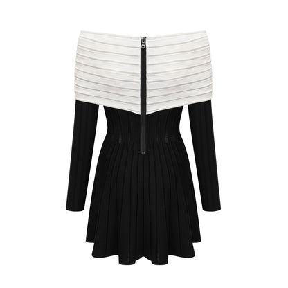 A black offshoulder mini dress with a bow detail and knit fabric featuring a formfitting silhouette