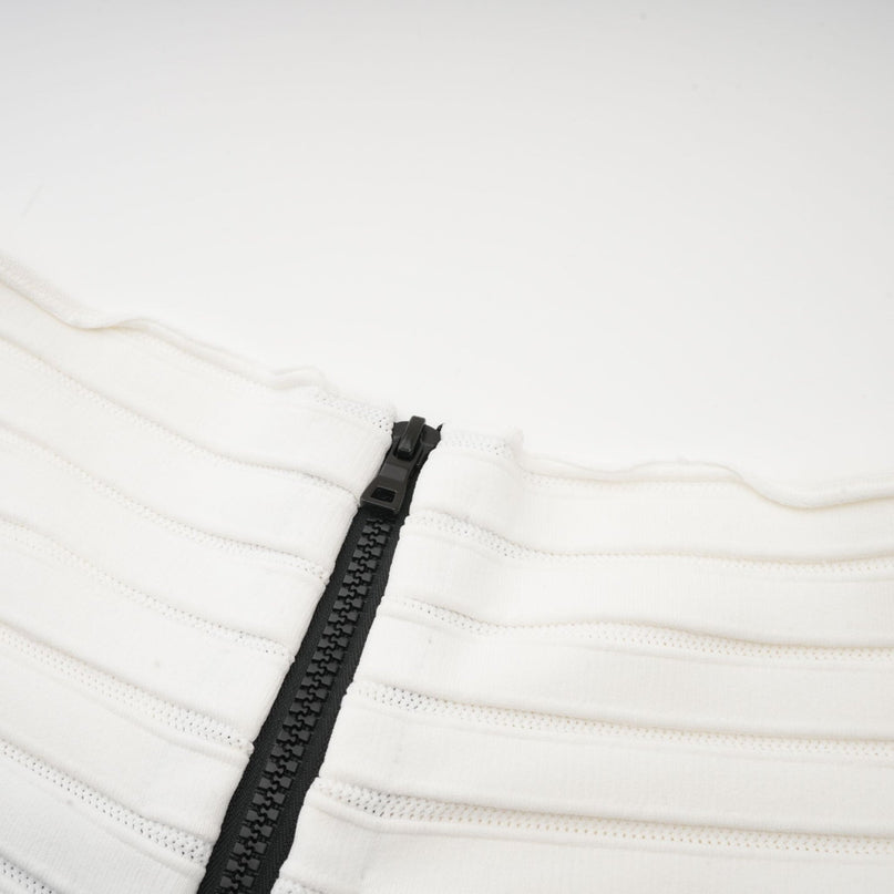 A black offshoulder mini dress with a bow detail and knit fabric worn by a model