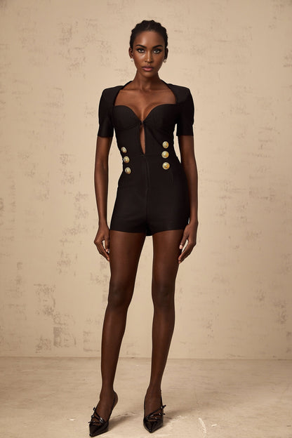 A black playsuit with embossed buttons named Solene featuring a short design with a fitted silhouette and decorative button details