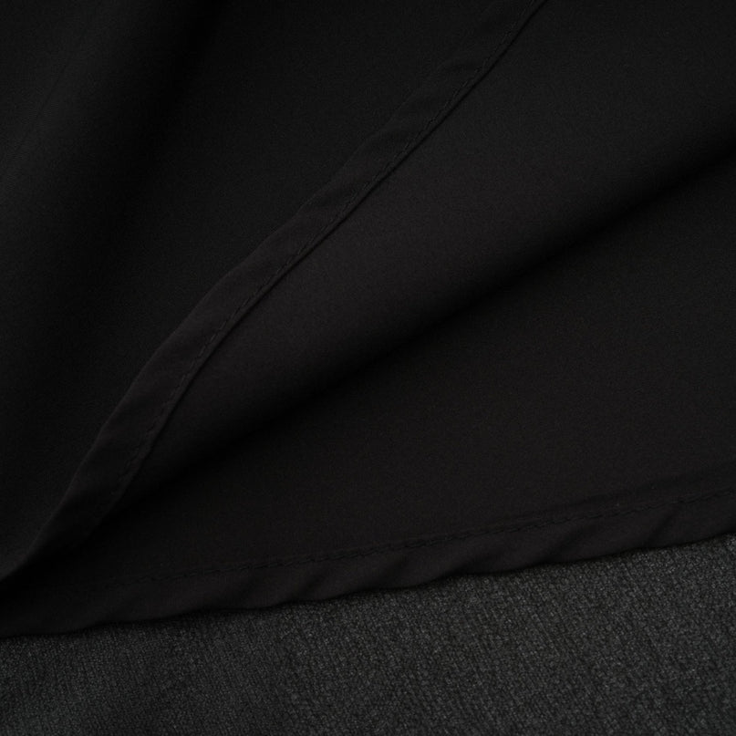 A black pleated midi dress with a button front closure featuring long sleeves and a fitted waist