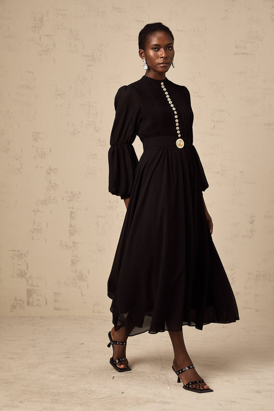 A black pleated midi dress with a buttonfront closure named Viviane